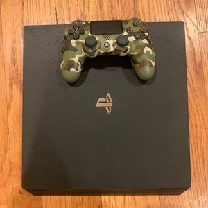 PS4 PRO 1TB WITH CAMOUFLAGE DUALSHOCK CONTROLLER.